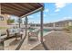 Inviting backyard with a covered patio, pool, and desert landscaping, ideal for outdoor relaxation at 3435 E Desert Trumpet Rd, Phoenix, AZ 85044