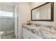 Bright bathroom boasts granite countertops, a large mirror, and shower stall at 3435 E Desert Trumpet Rd, Phoenix, AZ 85044