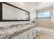 Double vanity bathroom with granite countertop and shower/tub combo at 3435 E Desert Trumpet Rd, Phoenix, AZ 85044