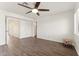 Spacious bedroom with hardwood floors and access to hallway bathroom at 3435 E Desert Trumpet Rd, Phoenix, AZ 85044