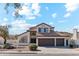 Two-story house with tile roof, two-car garage, and desert landscaping at 3435 E Desert Trumpet Rd, Phoenix, AZ 85044