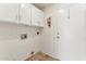 White cabinets and built-in shelving offer ample storage in this laundry room at 3435 E Desert Trumpet Rd, Phoenix, AZ 85044