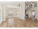 Spacious living room with high ceilings, tile floors, and a curved staircase at 3435 E Desert Trumpet Rd, Phoenix, AZ 85044