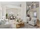 Elegant living room with high ceilings, staircase, and stylish furniture, creating a bright and inviting space at 3435 E Desert Trumpet Rd, Phoenix, AZ 85044