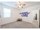 Well-lit bedroom featuring a ceiling fan and view of hallway at 3492 N 300Th Dr, Buckeye, AZ 85396