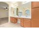Double vanity bathroom with wood cabinets and a large mirror at 4337 W Powell Dr, Phoenix, AZ 85087