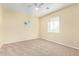 Bright bedroom featuring a ceiling fan and large window at 4337 W Powell Dr, Phoenix, AZ 85087