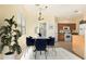 Dining area with a glass-top table and blue chairs at 4337 W Powell Dr, Phoenix, AZ 85087