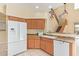 Kitchen with island, white appliances, and light wood cabinets at 4337 W Powell Dr, Phoenix, AZ 85087