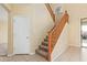 Wooden staircase with carpet runner and tile flooring at 4337 W Powell Dr, Phoenix, AZ 85087
