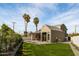 Spacious backyard featuring a manicured lawn, a modern home design, and two mature palm trees at 4445 E Roma Ave, Phoenix, AZ 85018