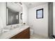 Stylish bathroom featuring modern fixtures, a wood vanity, and a tiled shower with a glass enclosure at 4445 E Roma Ave, Phoenix, AZ 85018