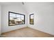 Bright bedroom with wood floors and large windows providing lots of natural light at 4445 E Roma Ave, Phoenix, AZ 85018