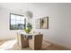 Bright dining area featuring a modern light fixture and a large window providing natural light and neighborhood views at 4445 E Roma Ave, Phoenix, AZ 85018