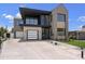 Striking modern home featuring a two-tone facade, balcony, and a spacious concrete driveway at 4445 E Roma Ave, Phoenix, AZ 85018