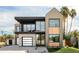 Stunning two-story modern home with a beautiful combination of stucco, brick, and wood accents and a well manicured lawn at 4445 E Roma Ave, Phoenix, AZ 85018