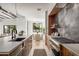 Modern kitchen featuring a large center island, stainless steel appliances, and sleek cabinetry with an adjacent dining area at 4445 E Roma Ave, Phoenix, AZ 85018