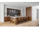 Well-appointed kitchen island with barstool seating and a view of the modern appliances and cabinetry at 4445 E Roma Ave, Phoenix, AZ 85018