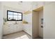 Well-lit laundry room features white cabinetry, a sink, drying rack, and a built-in area for a washer and dryer at 4445 E Roma Ave, Phoenix, AZ 85018