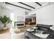 Bright living room features a modern fireplace, stylish seating, and an open floor plan to the kitchen at 4445 E Roma Ave, Phoenix, AZ 85018