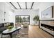 Inviting living room with modern fireplace, stylish furniture, and large sliding doors leading to the outdoor space at 4445 E Roma Ave, Phoenix, AZ 85018