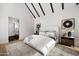 Bright main bedroom with beamed ceiling, bedside tables, and light colored rug at 4445 E Roma Ave, Phoenix, AZ 85018