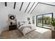 Bright main bedroom with beamed ceiling, sliding glass doors, and light colored rug at 4445 E Roma Ave, Phoenix, AZ 85018