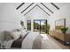 Bright main bedroom with beamed ceiling, sliding glass doors, and light colored rug at 4445 E Roma Ave, Phoenix, AZ 85018