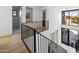 Bright staircase landing features modern railings, wood floors, and access to multiple rooms, including a bathroom at 4445 E Roma Ave, Phoenix, AZ 85018