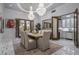 Elegant dining room featuring a large wooden table, chandelier, and access to a butler's pantry at 4715 N Launfal Ave, Phoenix, AZ 85018