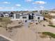 Modern home with desert landscaping, a paved driveway, and a three-car garage at 722 N Sun Rd, Apache Junction, AZ 85119