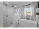 Bright bathroom featuring walk-in shower, soaking tub, mosaic tile floor and natural light at 9136 N 81St St, Scottsdale, AZ 85258