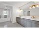 Bright bathroom featuring double sinks, grey vanity, modern fixtures, and soaking tub at 9136 N 81St St, Scottsdale, AZ 85258