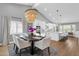 Elegant dining area featuring a modern chandelier, white chairs, and large windows for natural light at 9136 N 81St St, Scottsdale, AZ 85258