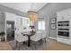 Dining room featuring a wine fridge, white cabinets, a large chandelier, and a dining table for six at 9136 N 81St St, Scottsdale, AZ 85258