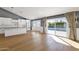 Kitchen extends to patio via sliding glass doors offering pool views with modern appliances, and hardwood flooring at 9136 N 81St St, Scottsdale, AZ 85258