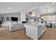 Open-concept kitchen with white cabinets, a large island, and seamless flow to the dining and living spaces at 9136 N 81St St, Scottsdale, AZ 85258