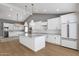 Beautiful kitchen featuring white cabinetry, marble countertops, stainless steel appliances and gorgeous hardwood flooring at 9136 N 81St St, Scottsdale, AZ 85258