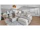 Open-concept living space with a large sofa, modern decor, and seamless flow to the kitchen and dining areas at 9136 N 81St St, Scottsdale, AZ 85258