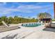 A perfect outdoor setting with a pristine pool, lounge chairs, and barbecue area surrounded by mature landscaping and blue sky at 9136 N 81St St, Scottsdale, AZ 85258