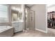 Modern bathroom with sleek fixtures, a glass-enclosed shower, and a view into the walk-in closet at 9426 W Daley Ln, Peoria, AZ 85383