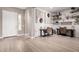 Bright home office featuring two desks, white brick accent wall, and decorative shelving for an inspiring workspace at 9426 W Daley Ln, Peoria, AZ 85383