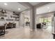 Open-concept living space with modern flooring, neutral tones, and seamless flow to the kitchen and outdoor area at 9426 W Daley Ln, Peoria, AZ 85383