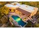 Aerial view of a luxury home with a pool, spa, outdoor living, and desert landscaping at 1084 N Boulder Dr, Carefree, AZ 85377
