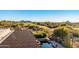 A backyard view of the pool, and a lush green golf course at 1084 N Boulder Dr, Carefree, AZ 85377