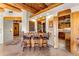 Interior bar area with wooden bar, beamed ceiling, and flagstone floors at 1084 N Boulder Dr, Carefree, AZ 85377