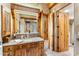 Bathroom vanity area featuring granite countertop, wood cabinets, and access to walk-in closet at 1084 N Boulder Dr, Carefree, AZ 85377