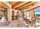 Inviting dining area featuring a beamed ceiling, flagstone floors, and mountain views at 1084 N Boulder Dr, Carefree, AZ 85377