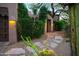 Charming entryway featuring desert landscaping, stone pathway, and warm exterior lighting at 1084 N Boulder Dr, Carefree, AZ 85377