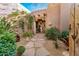 Charming entryway featuring desert landscaping, stone pathway, and wooden gate at 1084 N Boulder Dr, Carefree, AZ 85377